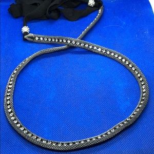 Silver necklace with clear stones.